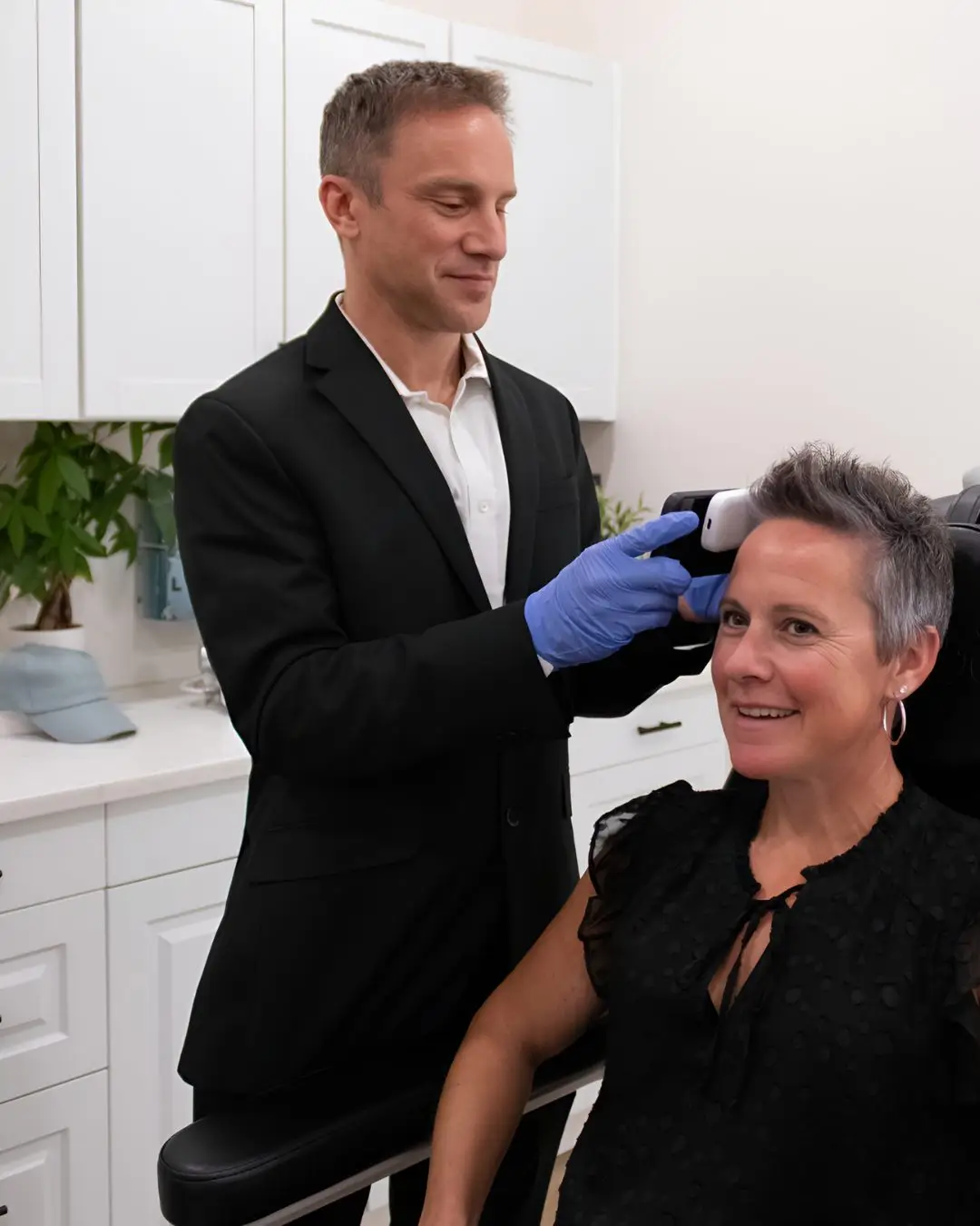 Dr. Justin Arambasick performing a scalp and hair loss assessment in Dayton, Ohio
