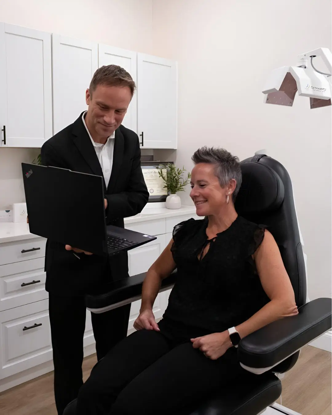 Dr. Justin Arambasick reviewing hair loss options with a patient during an FUE hair transplant consultation in Dayton, Ohio